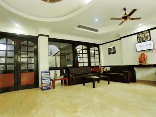 a living room with couches and a ceiling fan at Hotel Panickers Residency - Ajmal Khan Market Karol Bagh in New Delhi