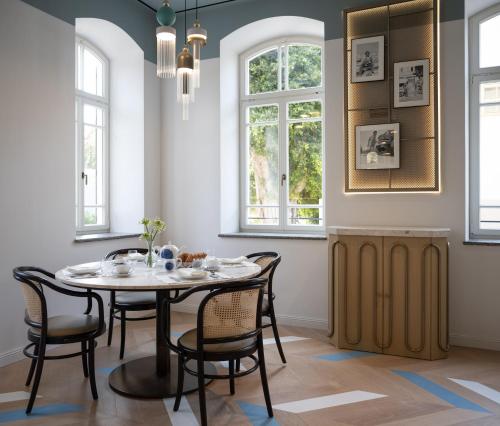 a dining room with a table and chairs at Elkonin Tel Aviv - MGallery Hotel Collection in Tel Aviv