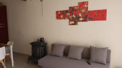 a living room with a couch and a painting on the wall at La Limonaia Country House in Monteriggioni