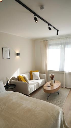 a living room with a couch and a table at Zentral & Modern Nähe Düsseldorf und Köln in Wuppertal