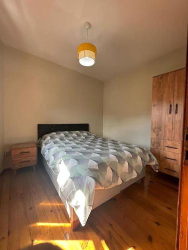 een slaapkamer met een bed en een houten vloer bij Taksimde teraslı daire in Istanbul