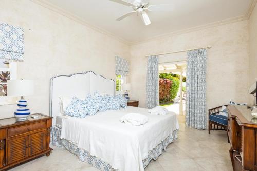 a bedroom with a bed with blue and white pillows at Lonetrees - Large Luxury Private Villa w Pool in Saint James