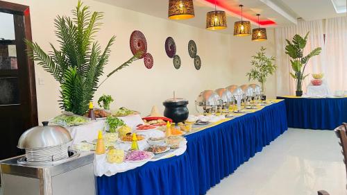 a long table with plates of food on it at Aron International Hotel in Juba