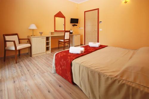 1 dormitorio con cama, escritorio y espejo en Ta 2 Pefka - Petros Italos en Neos Marmaras