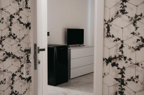 a door leading to a room with a television at Greta Apartments in Taranto