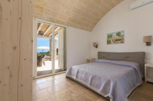 Postel nebo postele na pokoji v ubytování Villa Eneide by Perle di Puglia