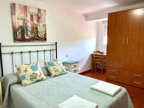 1 dormitorio con 1 cama y vestidor en Casa Los Kikos By Solymar Holiday, en Alcaucín