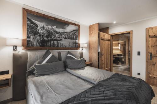 1 dormitorio con 1 cama con una foto en la pared en Chalet Ruhpolding Bayern en Ruhpolding