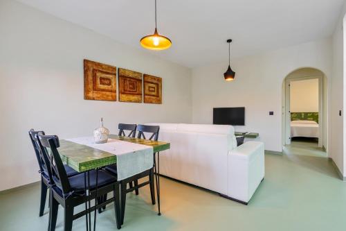 a dining room with a table and a white couch at Carpa in Riumar