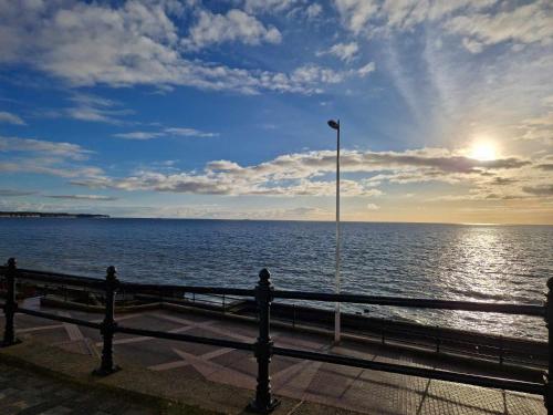 a view of the ocean from a pier with a street light at The Coastal Hideaway in Bridlington
