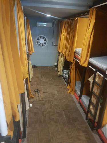 a hallway in a camper with yellow curtains at Rubikz Hostel & Cafe in Surabaya