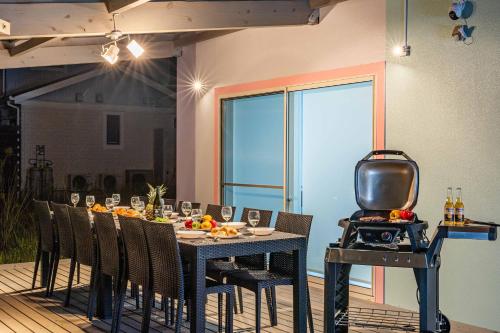 a dining room with a table with chairs and a grill at Nanki Shirahama Venus in Shirahama