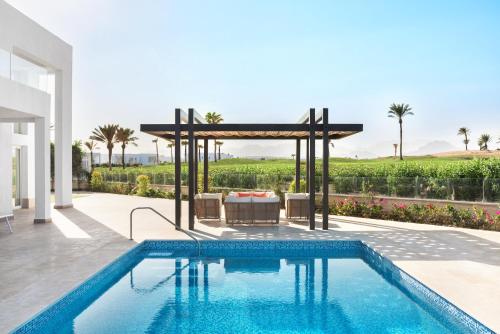 a villa with a swimming pool and a gazebo at Pickalbatros Golf Luxury Suites - All Inclusive in Sharm El Sheikh