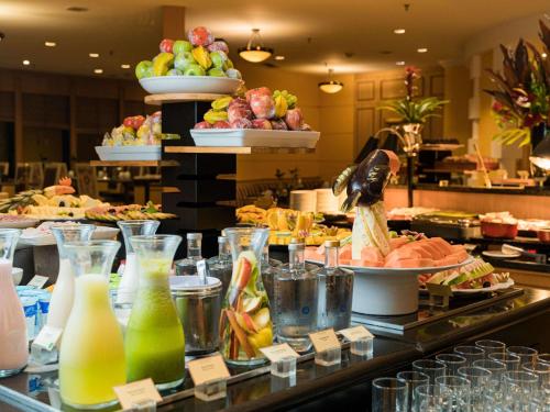 a buffet line with a lot of food and drinks at Grand Mercure Sao Paulo Ibirapuera in São Paulo