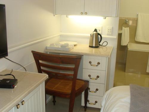 a kitchen with a desk with a tea kettle on it at Lonehill - Suite 1 in Sandton