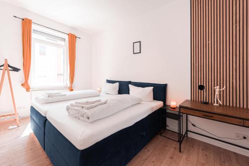 a bedroom with a large bed and a window at unique Cityresidenz nähe Münster - WE01 in Ulm