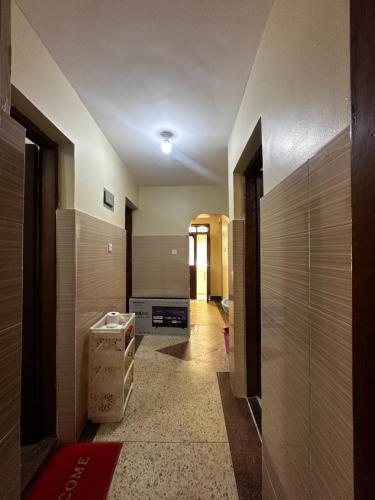 a hallway with wooden walls and a hallway with boxes at Yahya Apartments in Ngambo