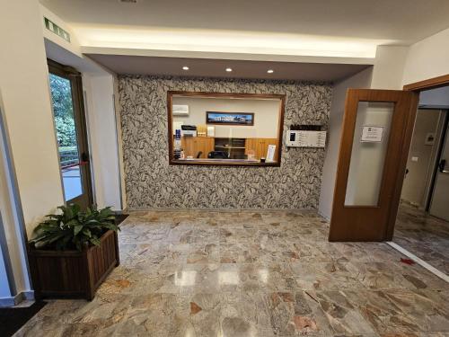 an empty lobby with a mirror and a room at La Casa di Nazareth in Rome