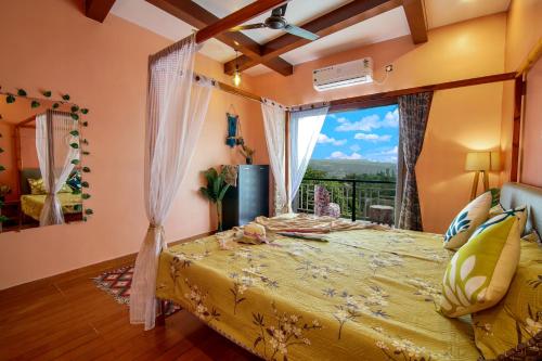 a bedroom with a large yellow bed with a window at Elsewhere Villa by Hill Staytion in Mahabaleshwar