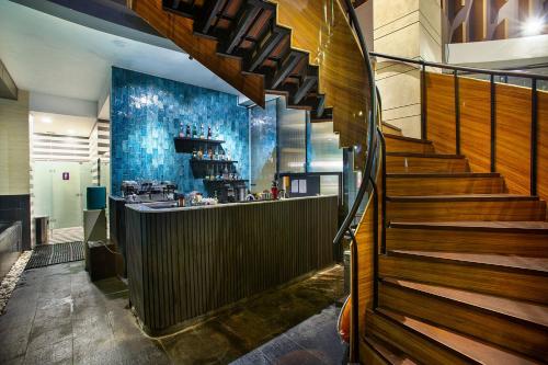 a staircase leading up to a bar in a building at THE 1O1 Jakarta Sedayu Darmawangsa in Jakarta