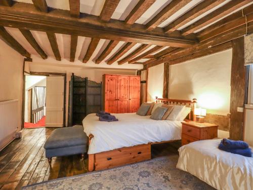 a bedroom with two beds and a wooden ceiling at Flushing House in Rye