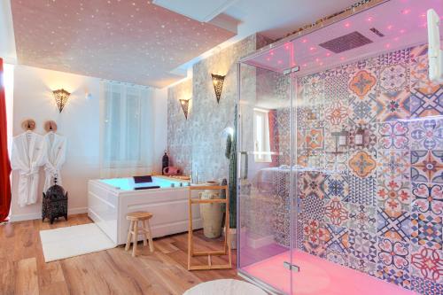 a bathroom with a shower and a sink at L' Oriental Suite de Luxe in Serrières
