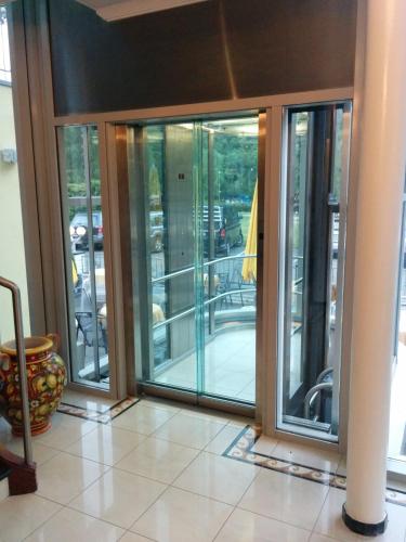 a room with sliding glass doors in a building at Hotel Seemöwe in Simmerath