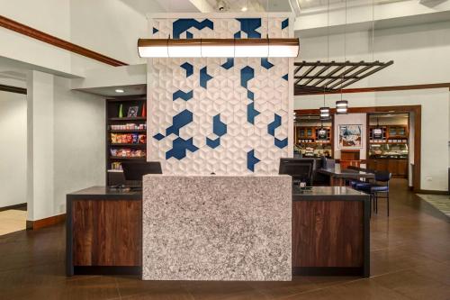 a lobby of a store with a counter and chairs at Hyatt Place Louisville-East in Louisville