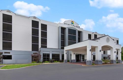 a white building with a sign on it at Hyatt Place Louisville-East in Louisville