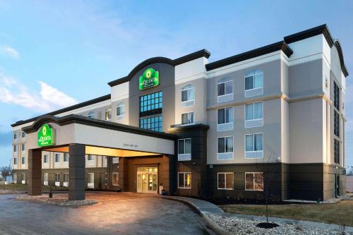 a large white building with a sign on it at La Quinta by Wyndham Omaha Airport Downtown in Omaha