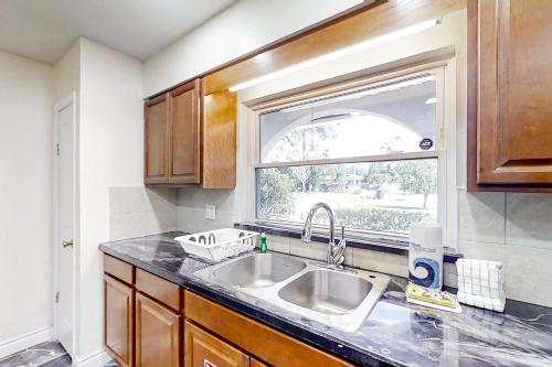 a kitchen with a sink and a window at By the Beach - Full Property in Jacksonville