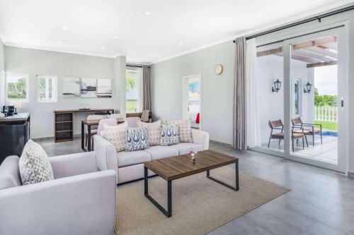 a living room with a couch and a table at Ramada by Wyndham St Kitts Resort in Newton Ground