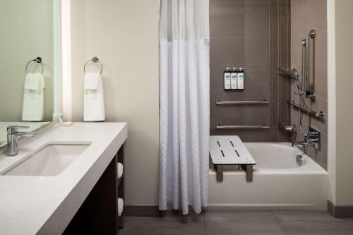 a bathroom with a tub and a sink and a shower at Hyatt House Vacaville in Vacaville