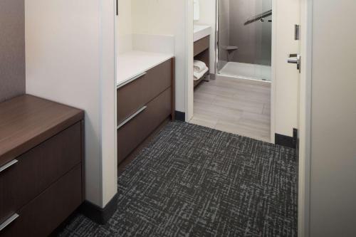 a bathroom with a walk in shower and a walk in closet at Hyatt House Vacaville in Vacaville