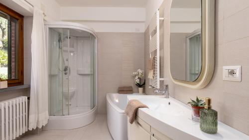 a bathroom with a sink and a shower and a toilet at VILLA ADISA 8, Emma Villas in Uzzano