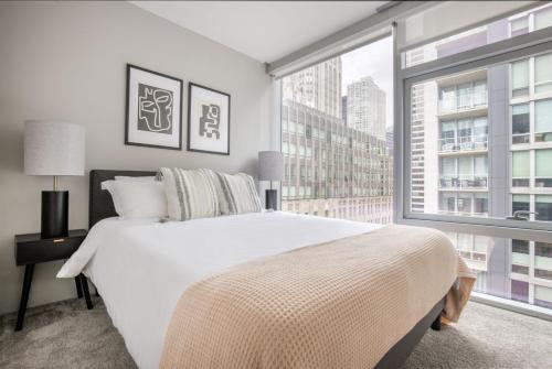 a bedroom with a large bed and a large window at Streeterville 2br w lounge pool nr Riverwalk CHI-1003 in Chicago