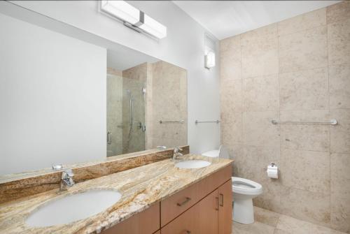 a bathroom with two sinks and a toilet at Streeterville 2br w lounge pool nr Riverwalk CHI-1003 in Chicago