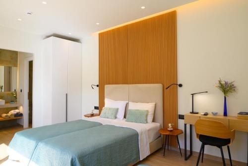 a hotel room with a bed and a desk and a desk at Majestic View Villas in Agios Nikolaos