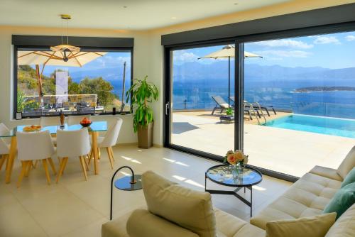 a living room with a couch and a table at Majestic View Villas in Agios Nikolaos