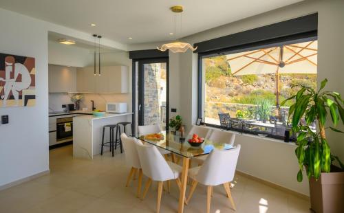 a kitchen and dining room with a table and chairs at Majestic View Villas in Agios Nikolaos