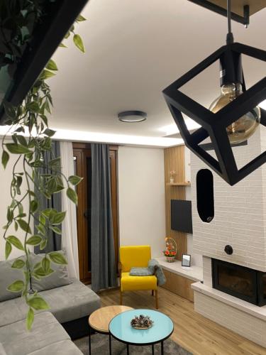 a living room with a couch and a table at Apartman Jahorina MD in Jahorina