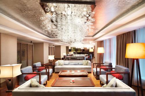 a living room with couches and a chandelier at Four Points by Sheraton Bijie in Bijie