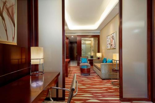 a hotel room with a hallway with a living room at Four Points by Sheraton Liupanshui in Shuicheng