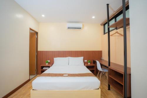 a bedroom with a bed and a loft bed at Sundaze Dormitel in Naga