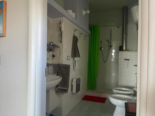 La salle de bains est pourvue de 2 toilettes et d'une douche verte. dans l'établissement Casa Vacanze “ Il Tiglio”, à Caiazzo