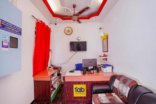 a room with a desk with a chair and a computer at FabExpress Lloyds Inn I - Nr Korea Embassy, Royapettah in Chennai