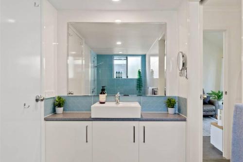 a bathroom with a white sink and a mirror at Noosaville Tropical Islander Resort in Noosaville
