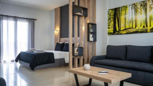a living room with a bed and a couch at ALBA SUITE APARTMENT in Kalabaka