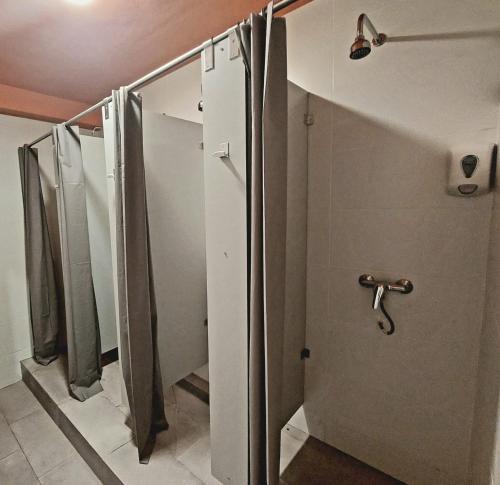 a row of shower stalls in a bathroom at Arc House Granada in Granada