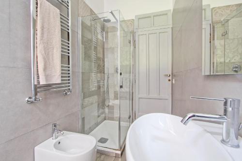 a bathroom with a sink and a shower and a toilet at Domvs Romae Apartment in Rome